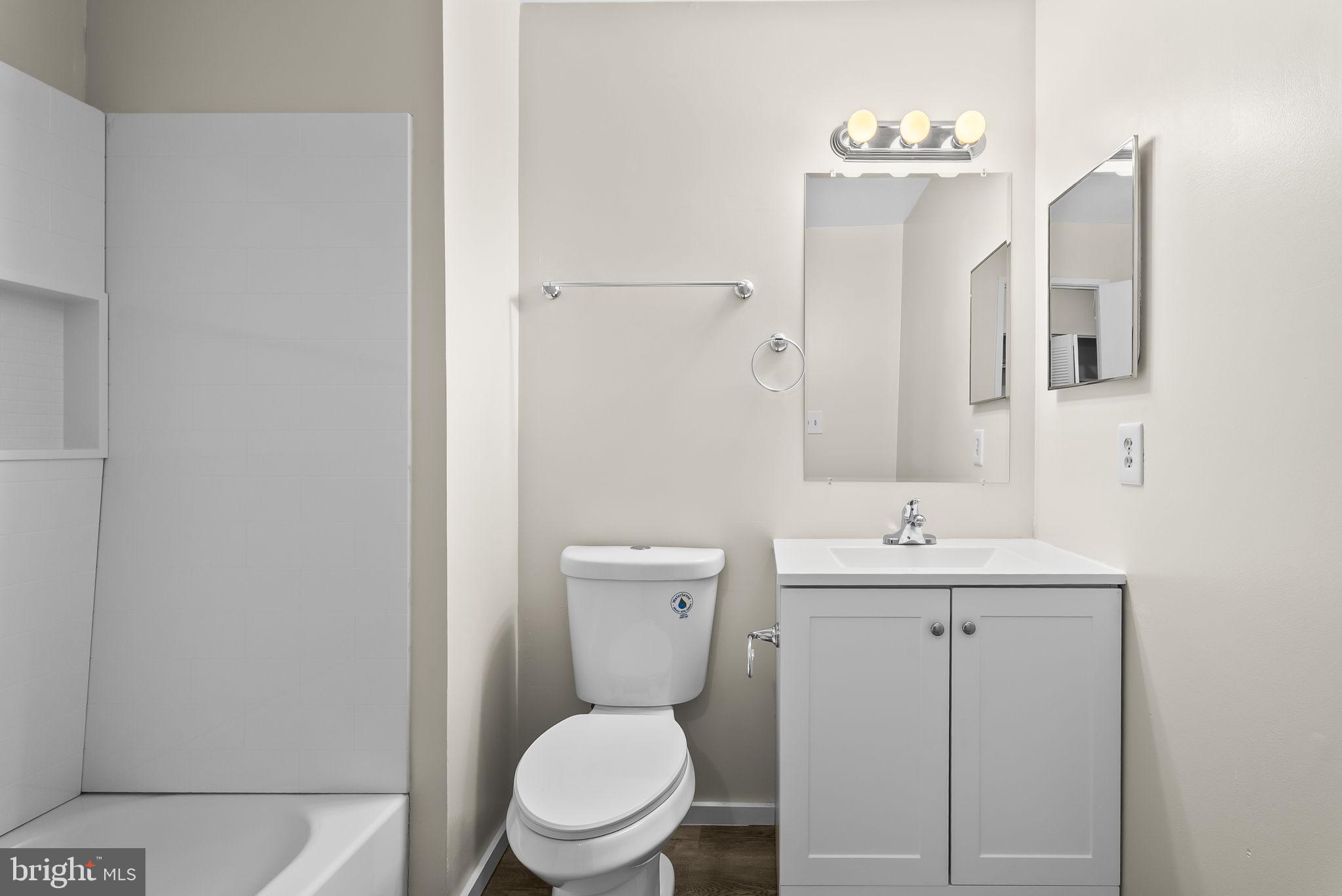 9413 Penshurst Court Gaithersburg, MD 20886 - Photo 22 of 32 a bathroom with a toilet a sink and mirror