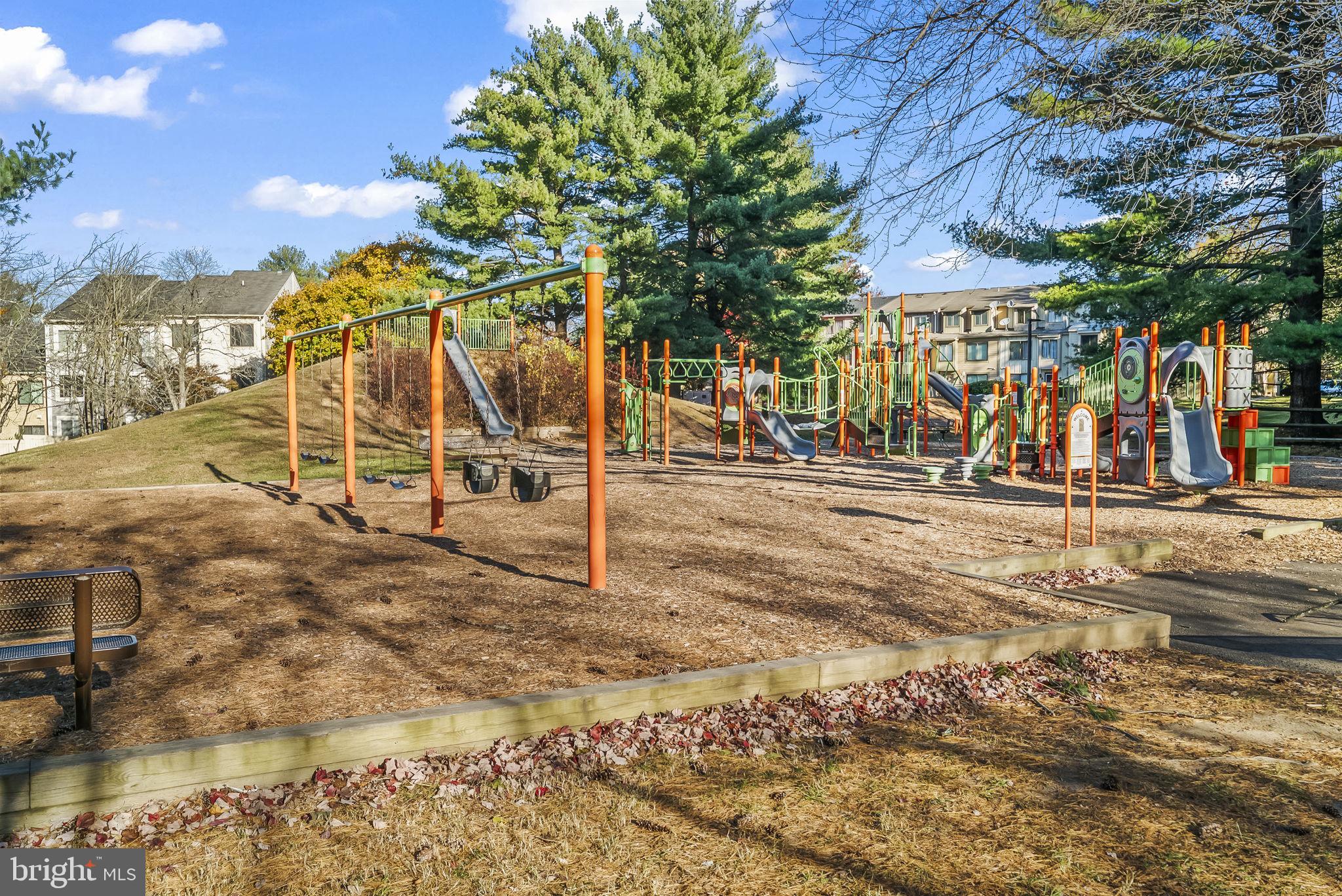 9413 Penshurst Court Gaithersburg, MD 20886 - Photo 31 of 32 a view of a park with swings and slides