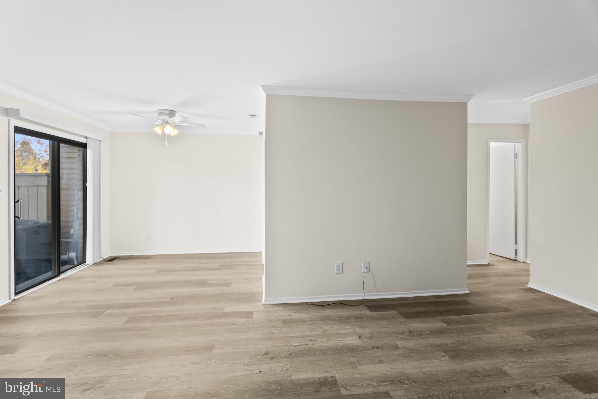 9413 Penshurst Court Gaithersburg, MD 20886 - Photo 9 of 32 a view of an empty room with wooden floor
