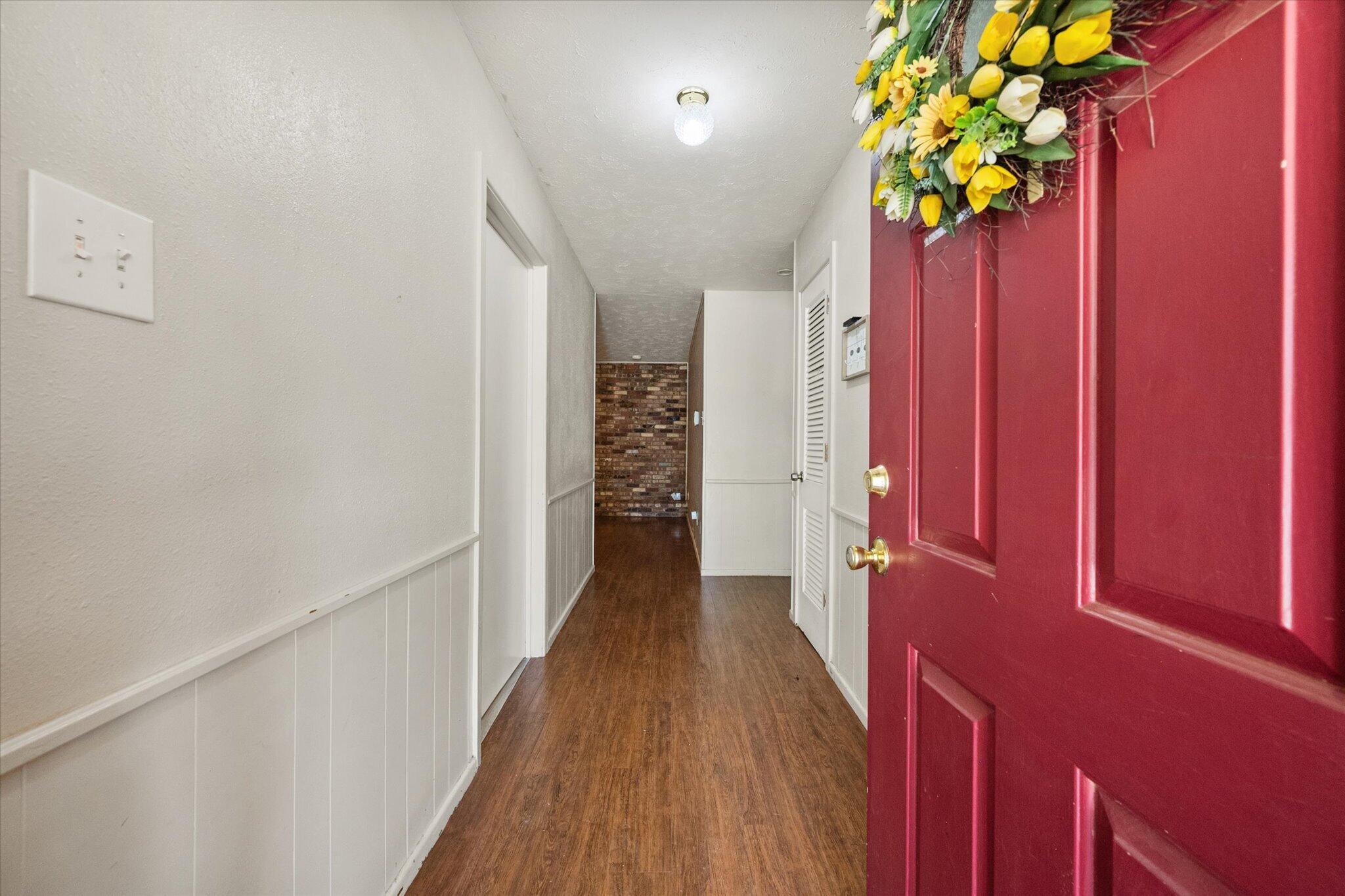 4604 27th Street Lubbock, TX 79410 - Photo 5 of 36 a view of a hallway with wooden floor and stairs