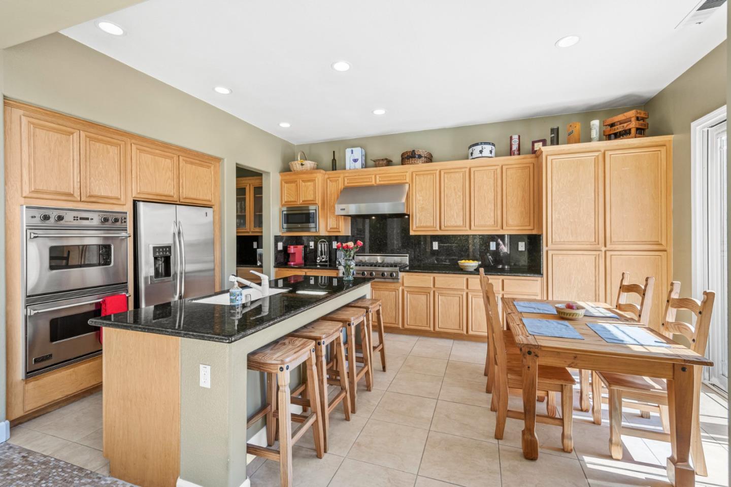 6850 Eagle Ridge Drive Gilroy, CA 95020 - Photo 11 of 51 a kitchen with kitchen island granite countertop lots of counter top space and stainless steel appliances
