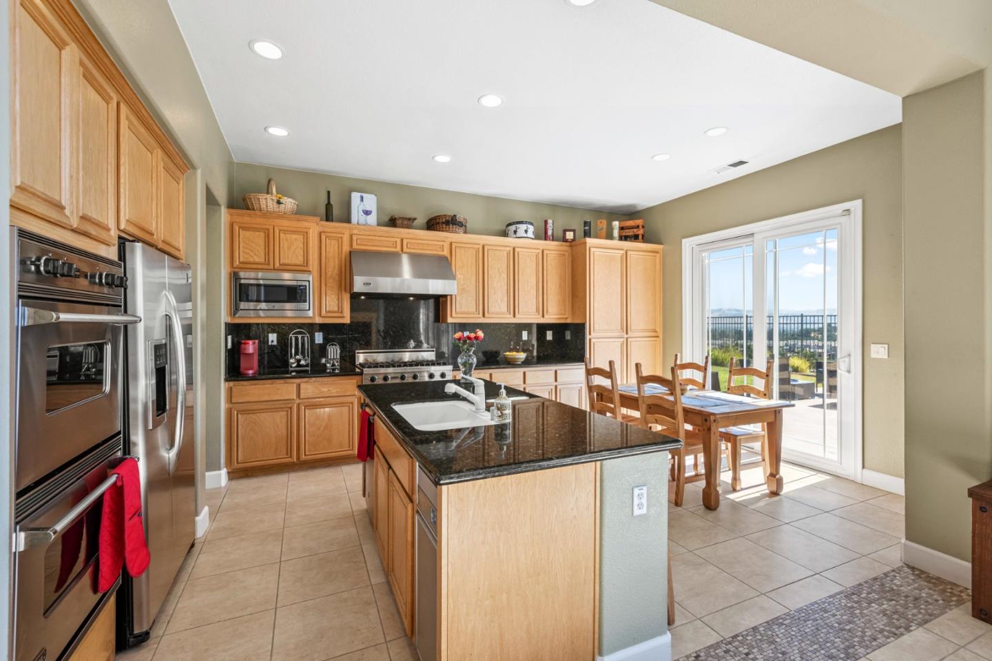 6850 Eagle Ridge Drive Gilroy, CA 95020 - Photo 10 of 51 a kitchen with stainless steel appliances granite countertop a stove and a refrigerator