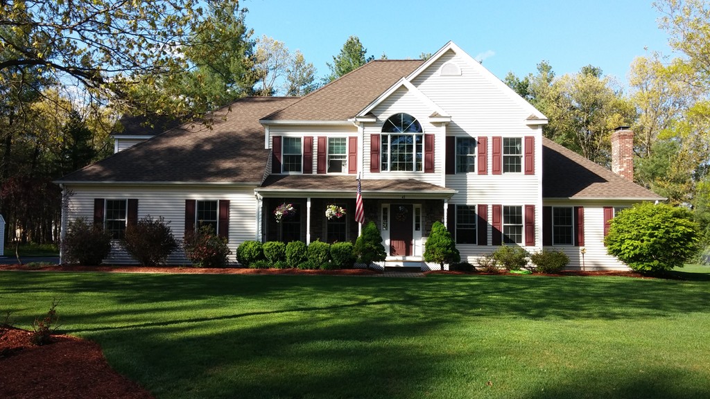 43 Shaker Road Shirley, MA 01464 - Photo 1 of 30 a view of a white house with a big yard and potted plants and large trees