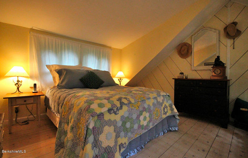 2 Grove Road Stockbridge, MA 01262 - Photo 10 of 25 a bedroom with a bed and a lamp on dresser