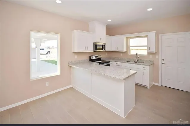 an empty room with a kitchen and a sink