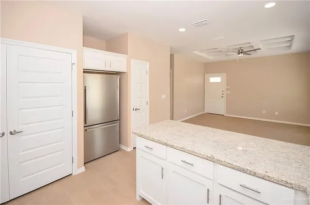 an empty room with a window and a ceiling fan