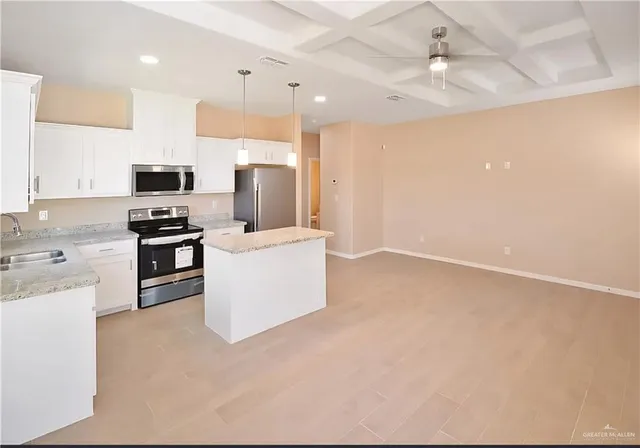a view of kitchen with refrigerator cabinets and a refrigerator