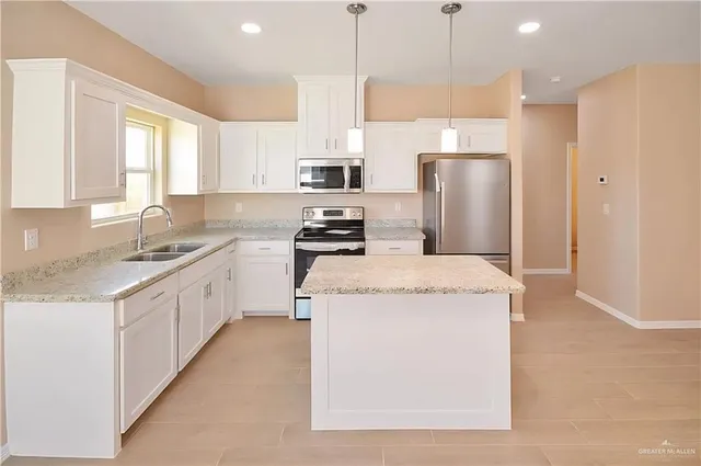 a kitchen with cabinets and stainless steel appliances