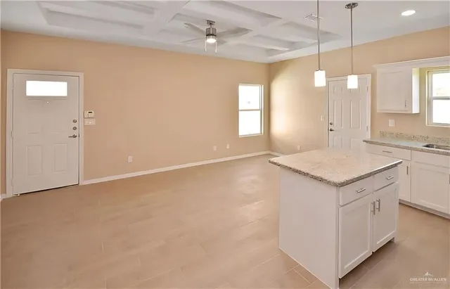 a kitchen with a refrigerator a sink and cabinets