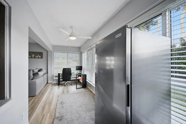 a view of a hallway with furniture and a window