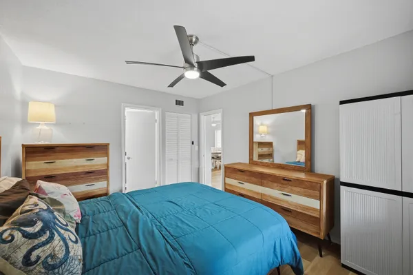 a bedroom with a bed and a large mirror