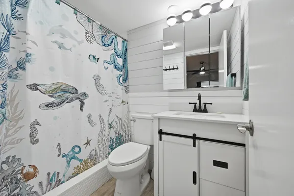 a bathroom with a sink toilet and shower