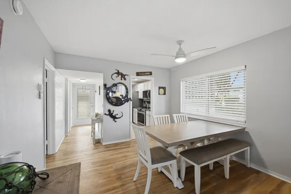 a dining room with furniture and wooden floor