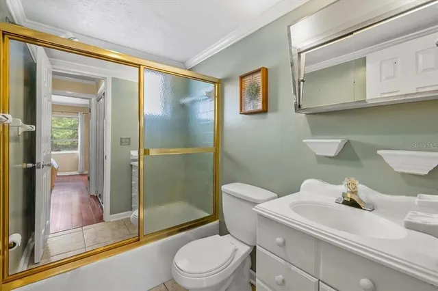 a bathroom with a toilet a sink and shower