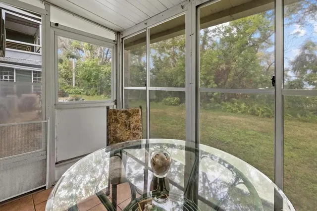 a view of a porch with furniture and floor to ceiling windows