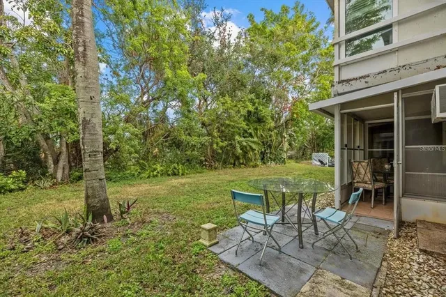 a view of a patio with table and chairs and potted plants