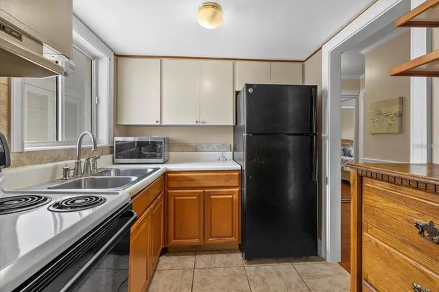 a kitchen with a refrigerator and a sink
