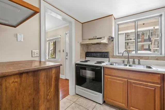 a kitchen with stainless steel appliances granite countertop a stove sink and cabinets
