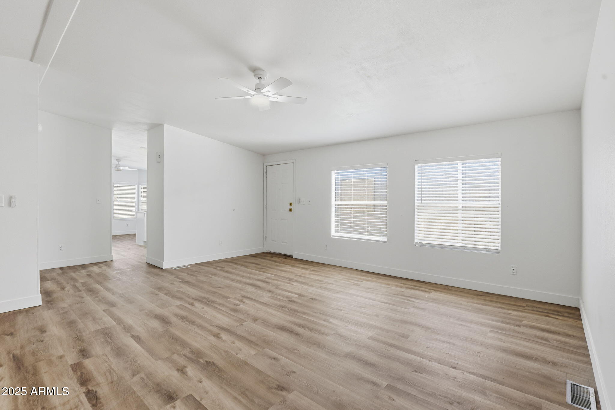 3500 South Tomahawk Road, Unit 142 Apache Junction, AZ 85119 - Photo 13 of 38 a view of empty room with wooden floor and fan