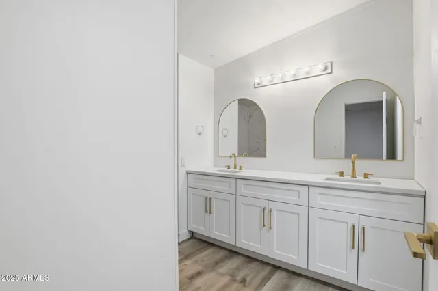 a bathroom with a double vanity sink and a mirror