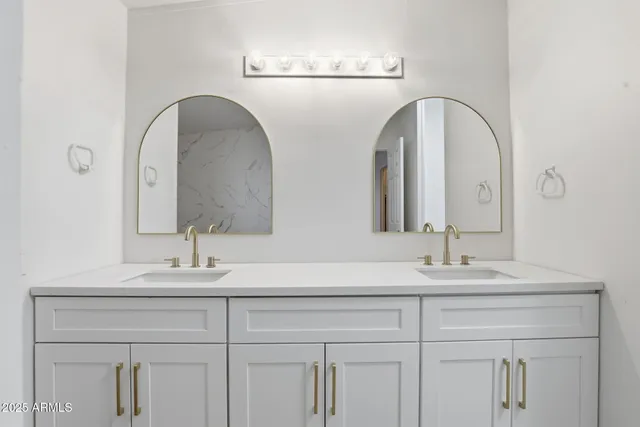 a bathroom with a double vanity sink and a mirror