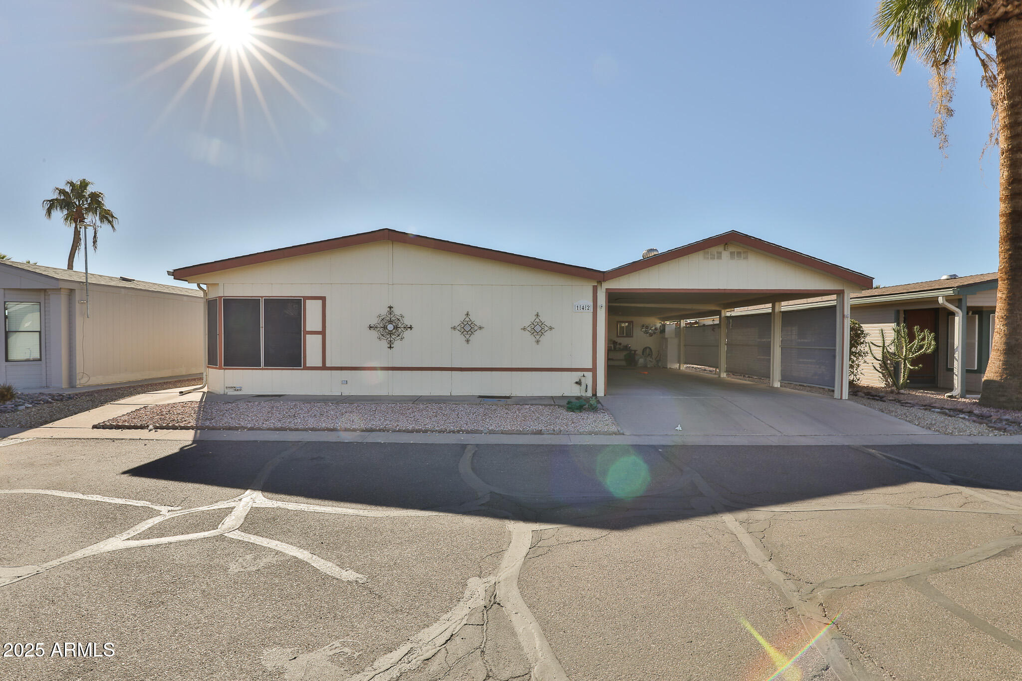 3500 South Tomahawk Road, Unit 142 Apache Junction, AZ 85119 - Photo 2 of 38 a front view of a house with garage