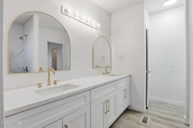 a bathroom with a double vanity sink and a mirror