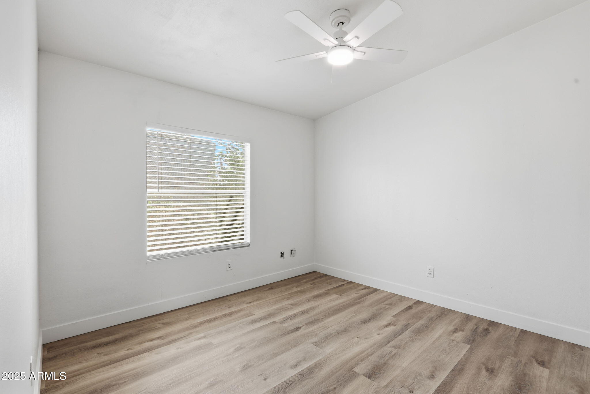 3500 South Tomahawk Road, Unit 142 Apache Junction, AZ 85119 - Photo 23 of 38 an empty room with a window and a ceiling fan