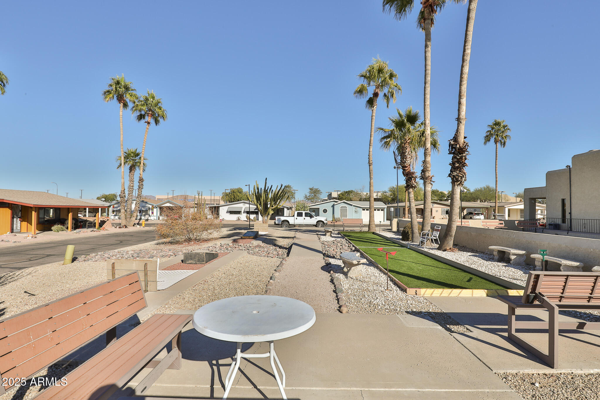 3500 South Tomahawk Road, Unit 142 Apache Junction, AZ 85119 - Photo 29 of 38 a view of a swimming pool with outdoor seating