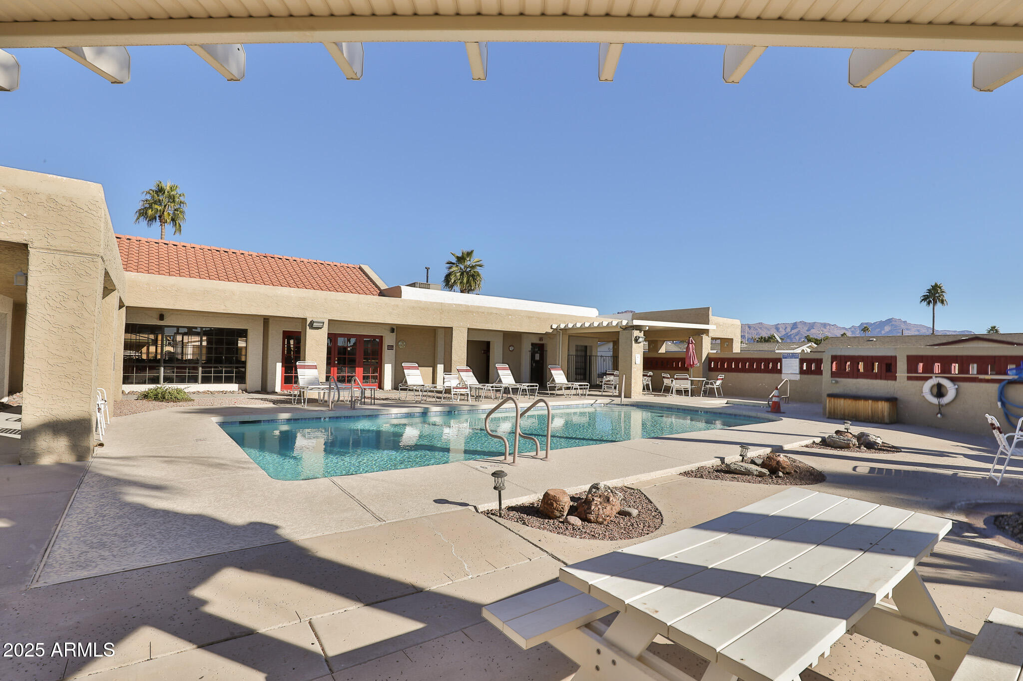 3500 South Tomahawk Road, Unit 142 Apache Junction, AZ 85119 - Photo 30 of 38 a view of a patio with table and chairs with wooden floor and fence