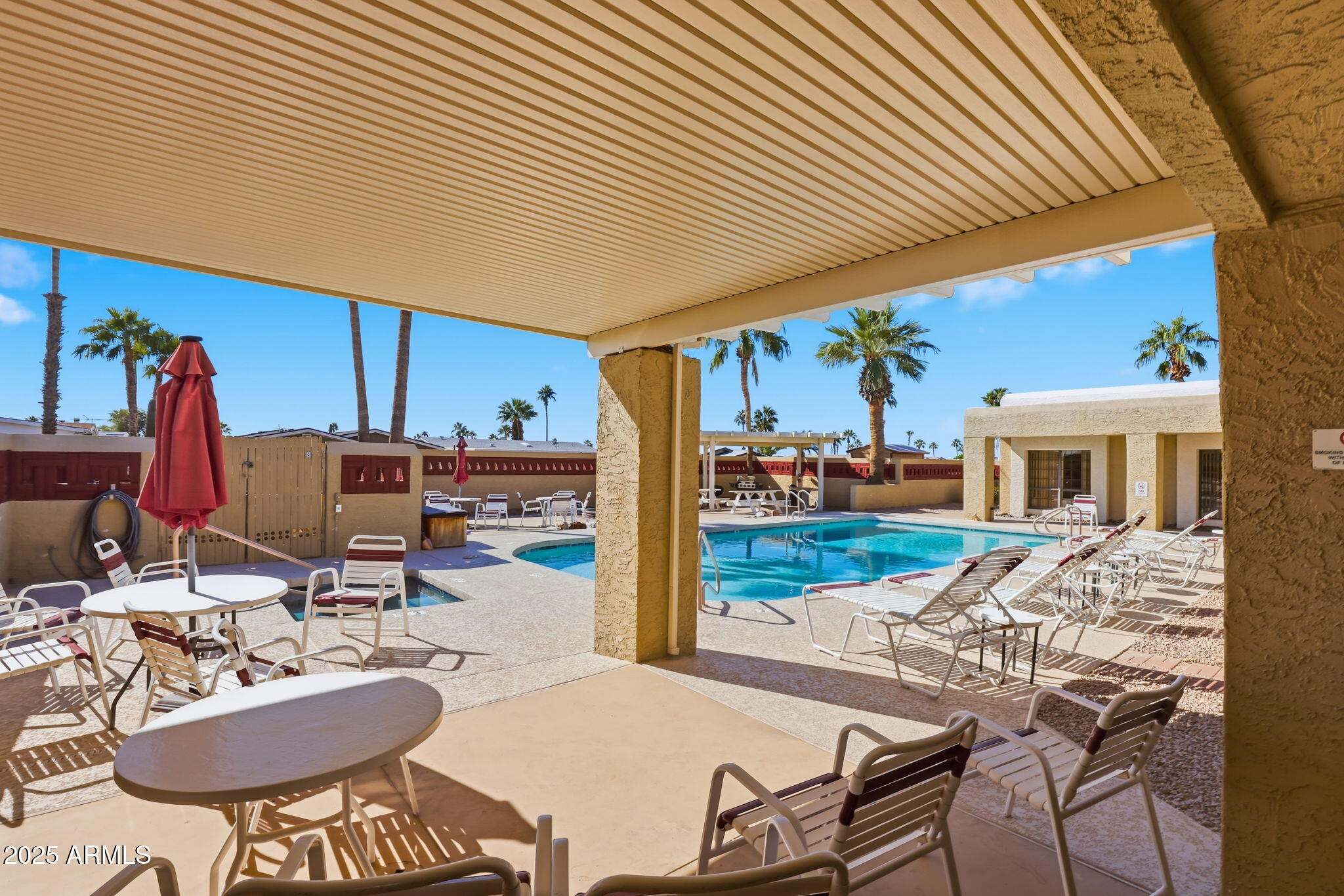 3500 South Tomahawk Road, Unit 142 Apache Junction, AZ 85119 - Photo 32 of 38 a view of a patio with table and chairs potted plants with wooden roof and stairs