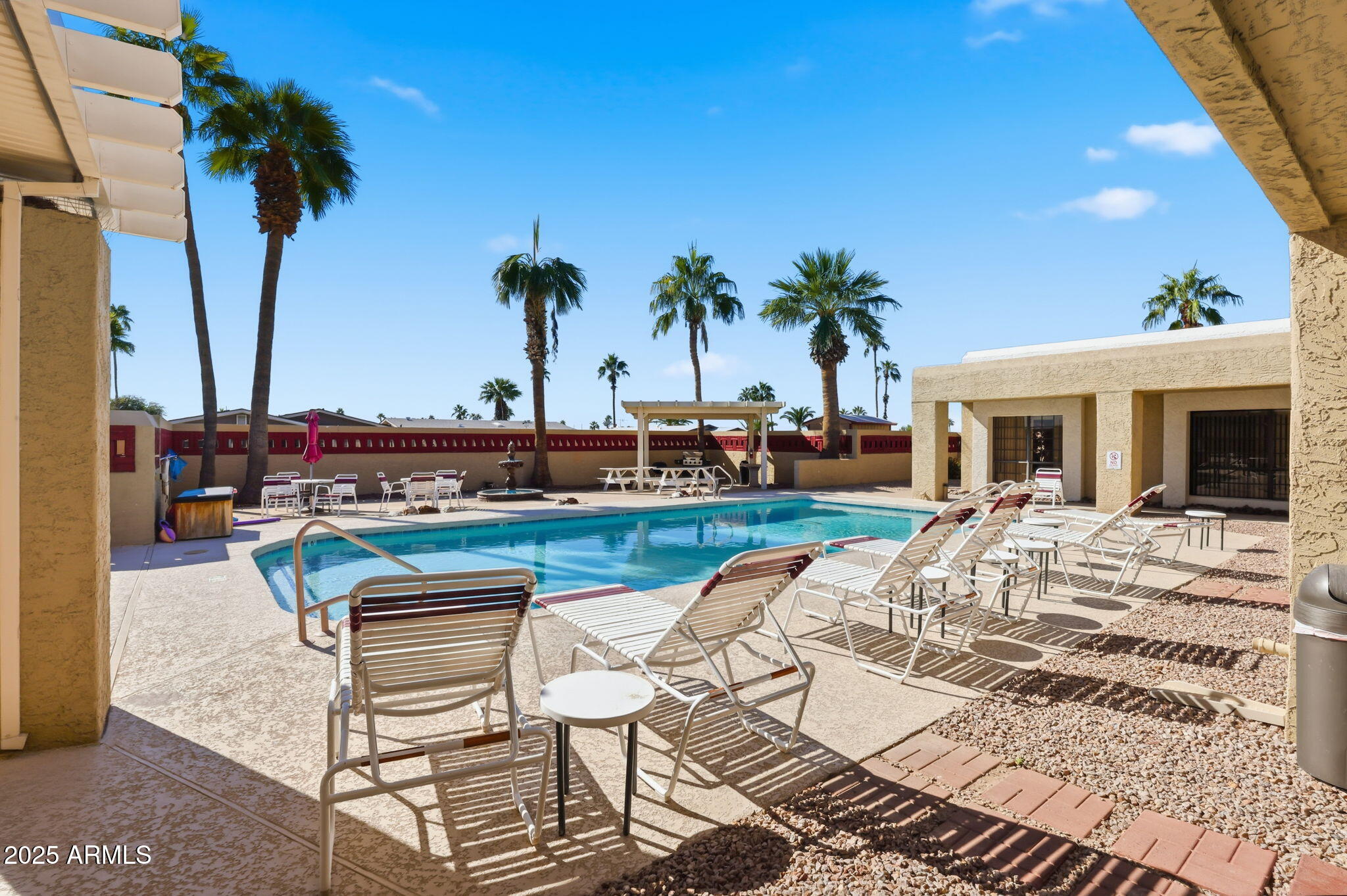 3500 South Tomahawk Road, Unit 142 Apache Junction, AZ 85119 - Photo 33 of 38 a view of a swimming pool with a table and chairs