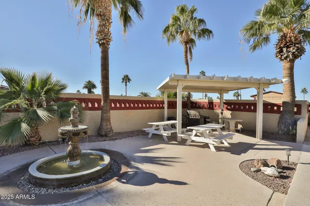 a swimming pool with outdoor seating yard and barbeque oven