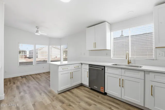 a kitchen with granite countertop white cabinets and white appliances