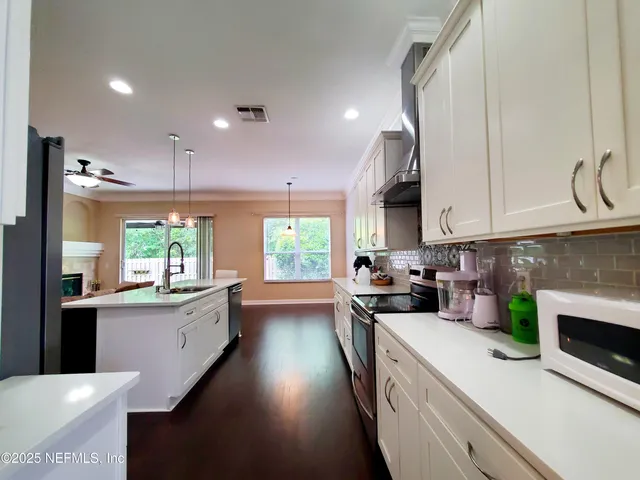 a kitchen with a stove a sink and a refrigerator