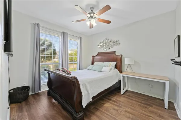 a bedroom with a bed and a ceiling fan