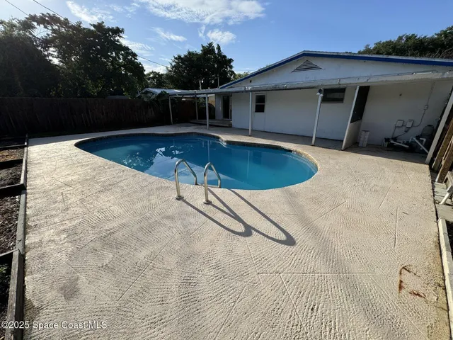 a view of a swimming pool with a yard