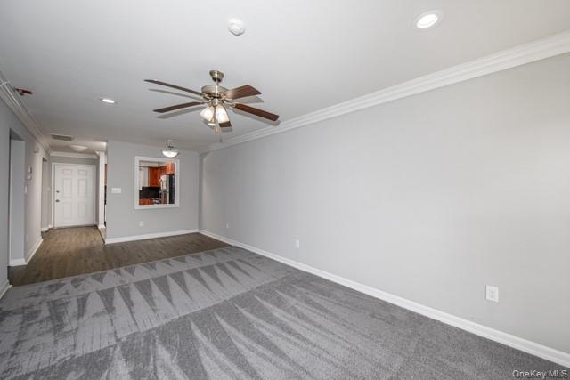 1703 Montauk Highway, Unit 1723 Moriches, NY 11955 - Photo 5 of 9 wooden floor in an empty room with a window