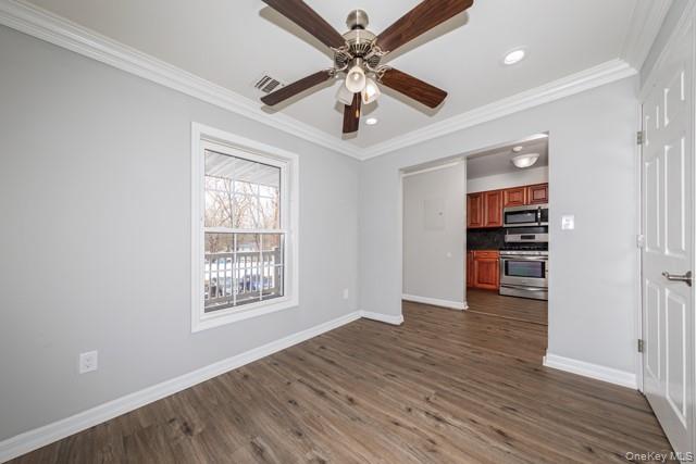 1703 Montauk Highway, Unit 1723 Moriches, NY 11955 - Photo 6 of 9 a view of an empty room with a window and wooden floor