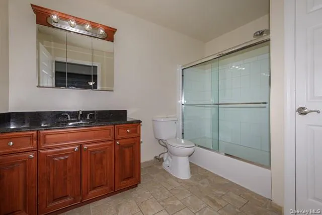 a spacious bathroom with a toilet sink and shower