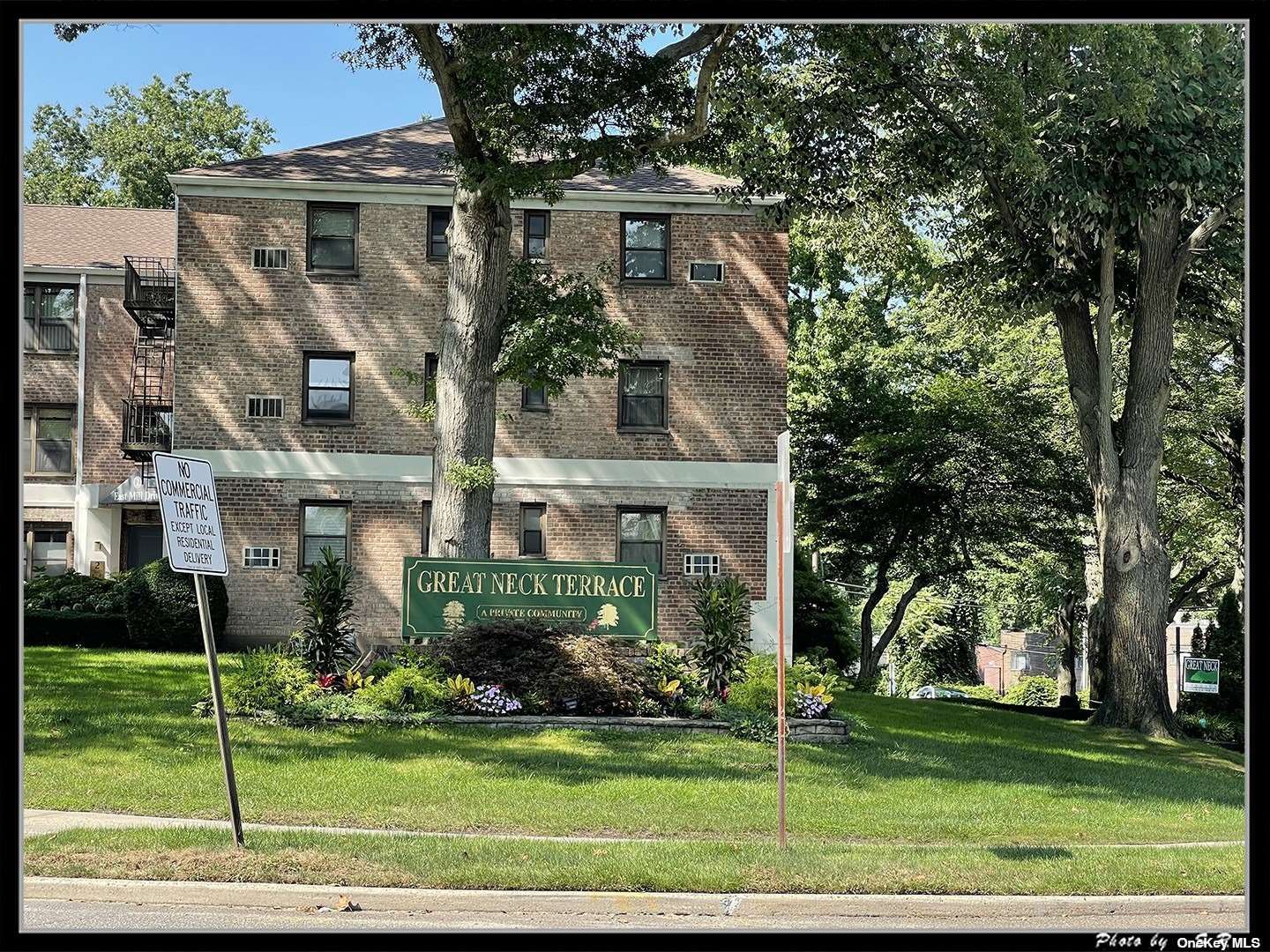 6 West Mill Drive, Unit 2C Great Neck, NY 11021 - Photo 1 of 1 a front view of a house with a yard