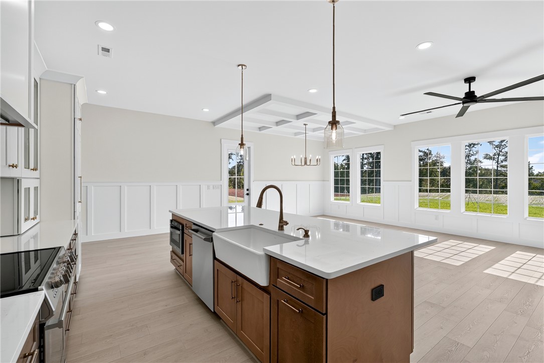 414 Blume Road Anderson, SC 29625 - Photo 23 of 50 Clean lines and classic wainscoting define this airy kitchen opening to the main living space.