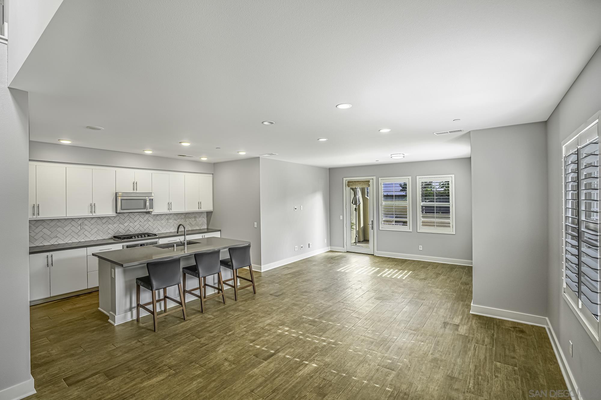145 Stonesteps Way Encinitas, CA 92024 - Photo 3 of 25 a view of a kitchen and dining room