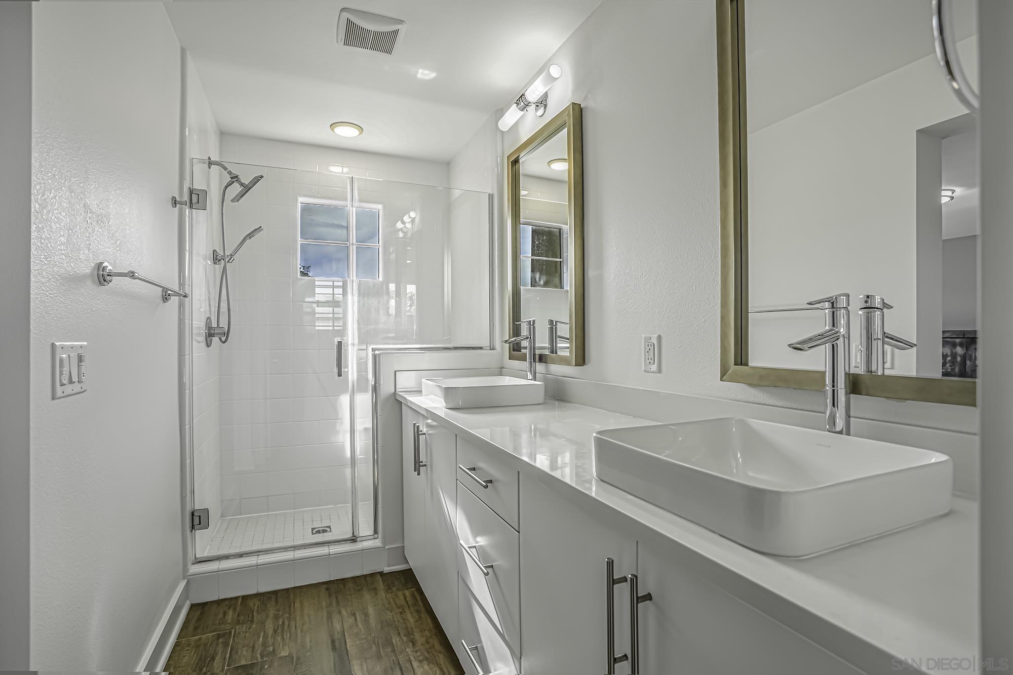 145 Stonesteps Way Encinitas, CA 92024 - Photo 9 of 25 a bathroom with a sink and a mirror with bathtub
