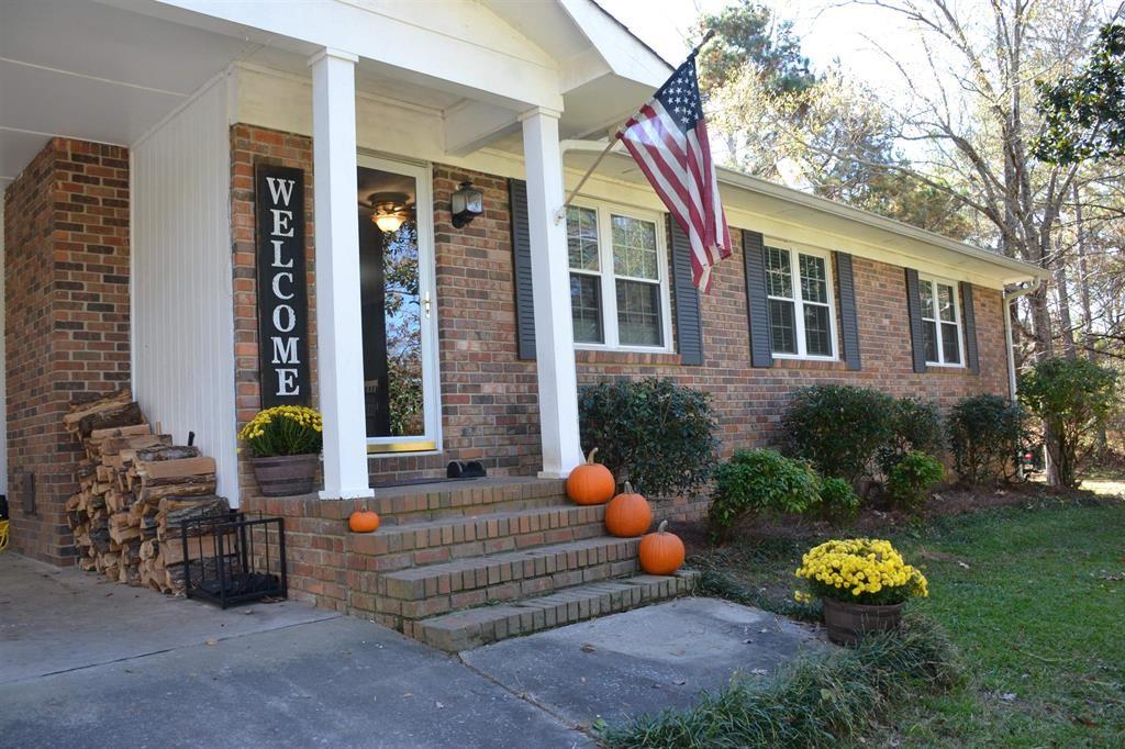 1362 Turkey Mountain Road Northeast Rome, GA 30165 - Photo 1 of 1 a front view of a house with patio and garden