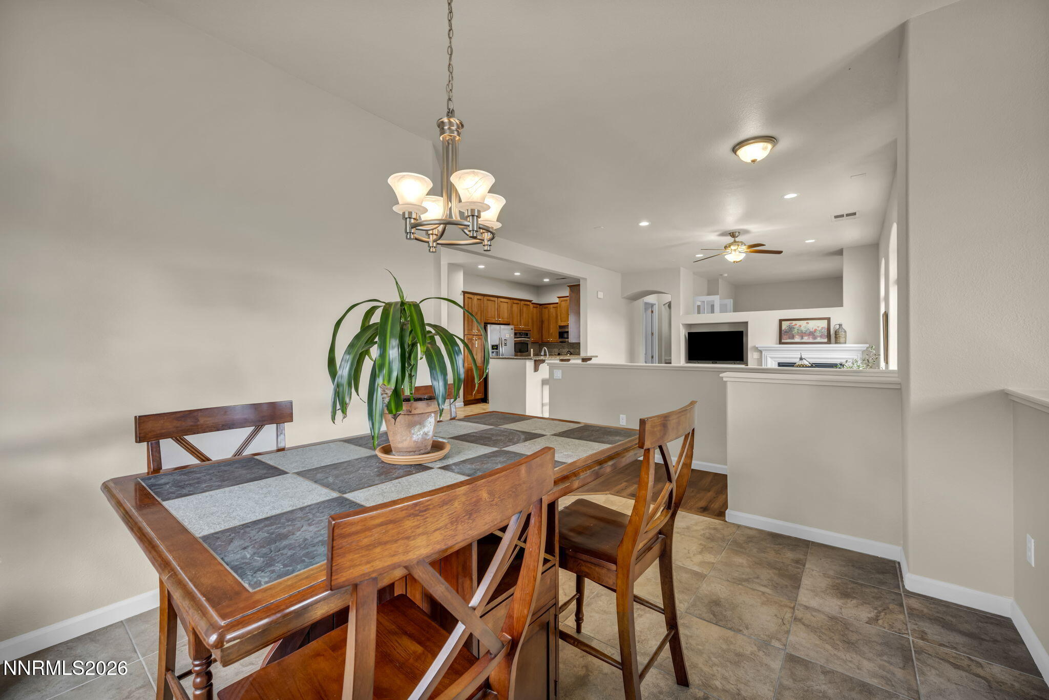 9900 Wilbur May Parkway, Unit 2405 Reno, NV 89521 - Photo 30 of 81 a view of a dining room with furniture and chandelier