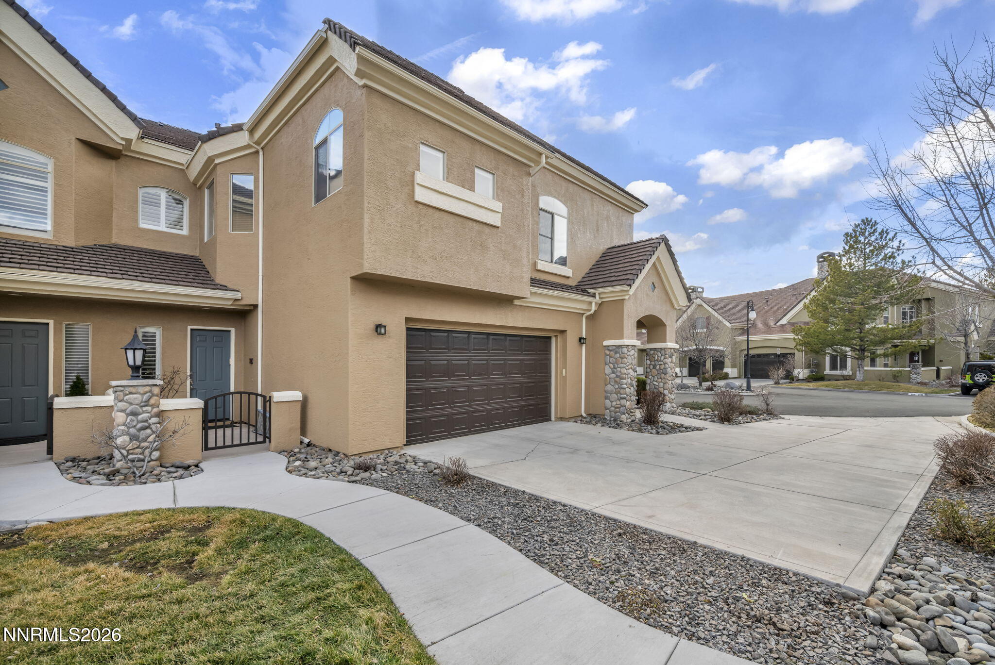 9900 Wilbur May Parkway, Unit 2405 Reno, NV 89521 - Photo 3 of 81 a front view of a house with a yard
