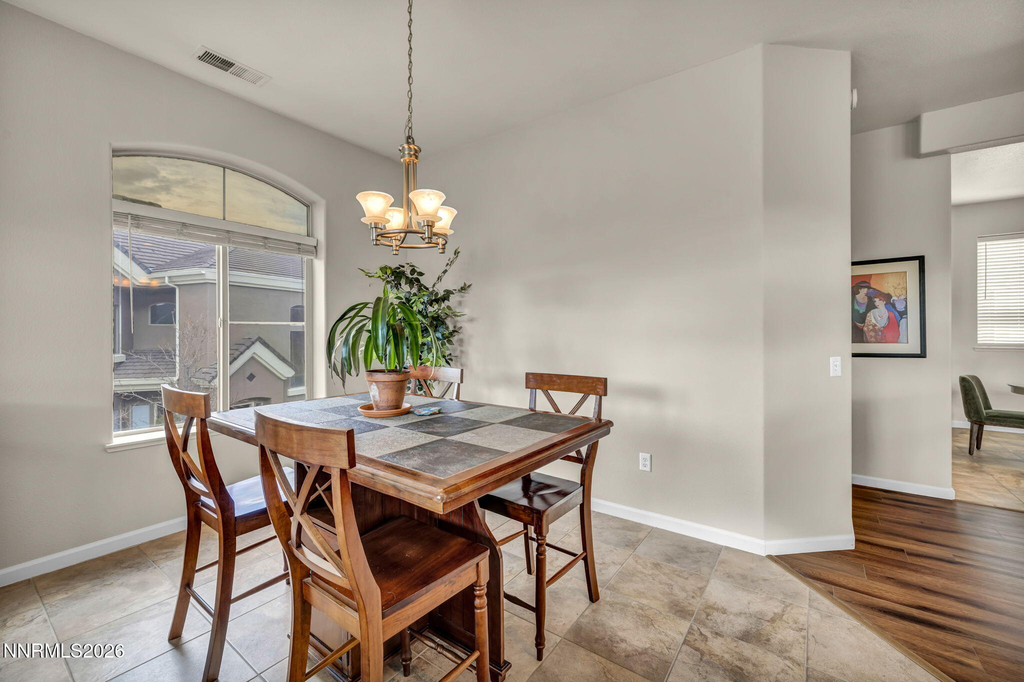 9900 Wilbur May Parkway, Unit 2405 Reno, NV 89521 - Photo 31 of 81 a dining room with furniture potted plants and wooden floor