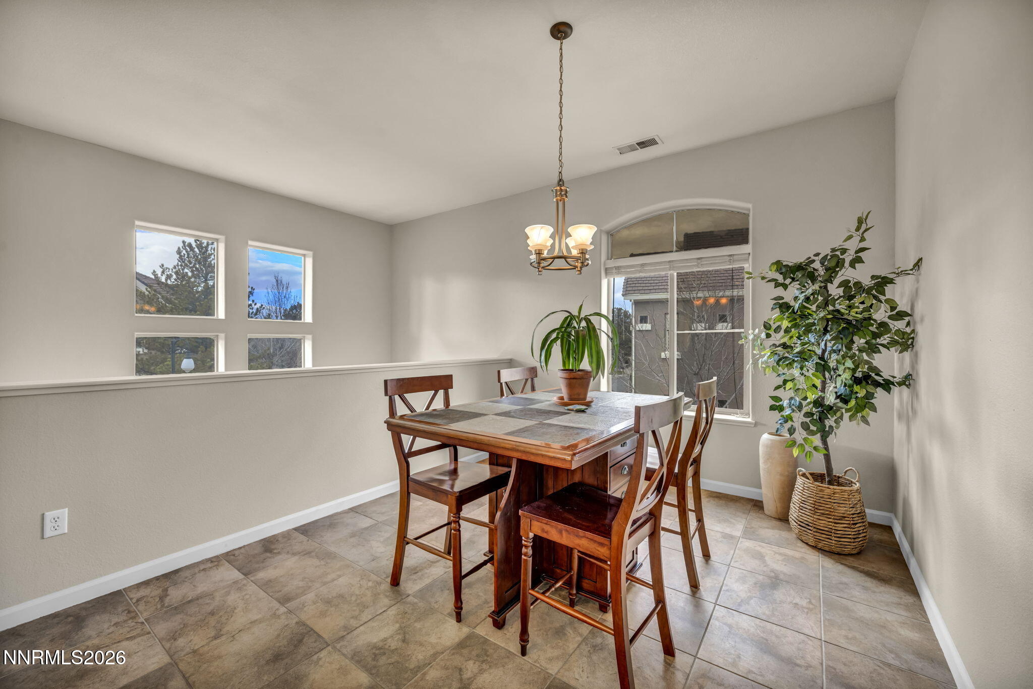 9900 Wilbur May Parkway, Unit 2405 Reno, NV 89521 - Photo 32 of 81 a view of a dining room with furniture and chandelier