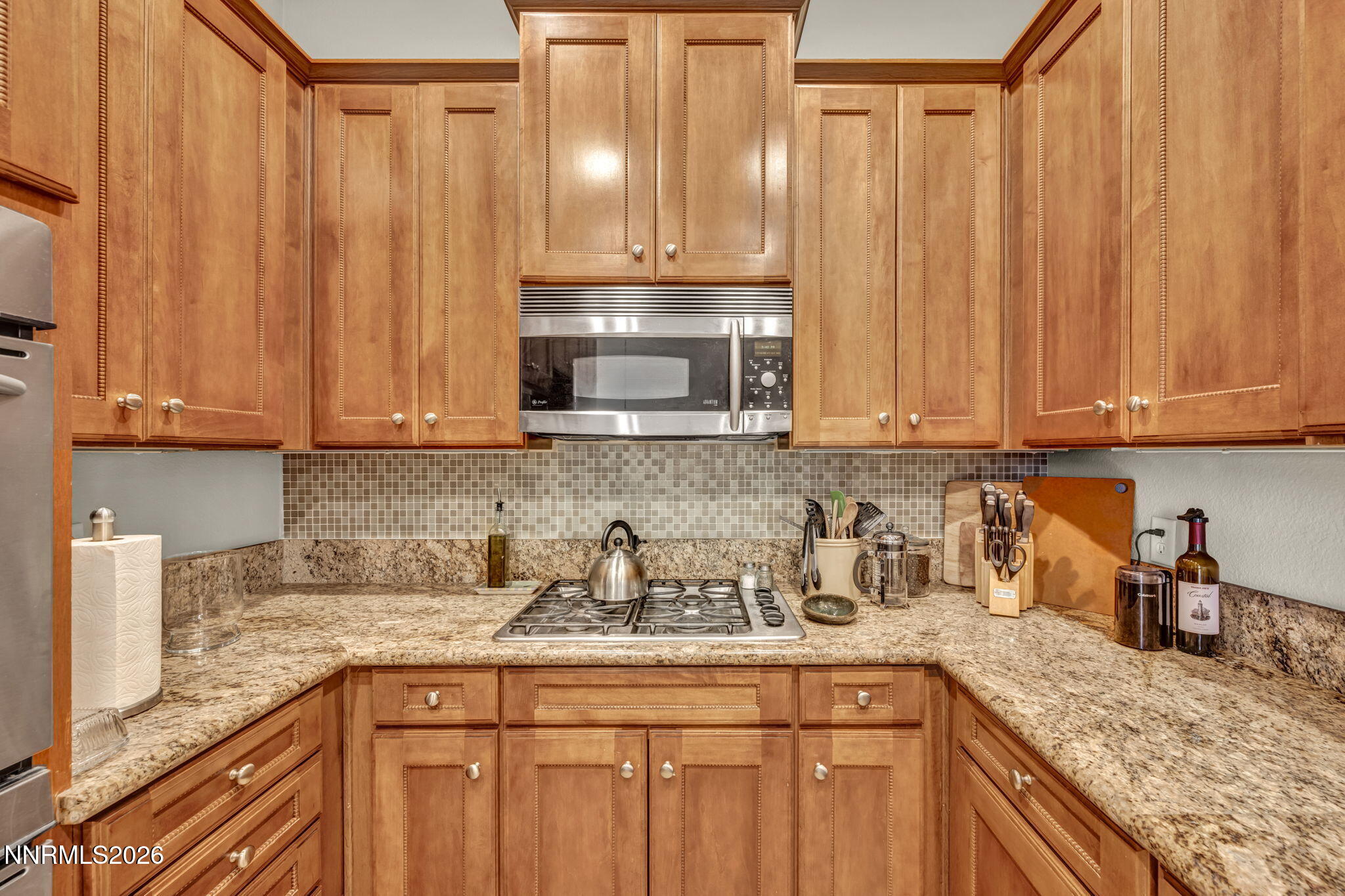 9900 Wilbur May Parkway, Unit 2405 Reno, NV 89521 - Photo 40 of 81 a kitchen with stainless steel appliances granite countertop a sink a refrigerator and a granite counter tops